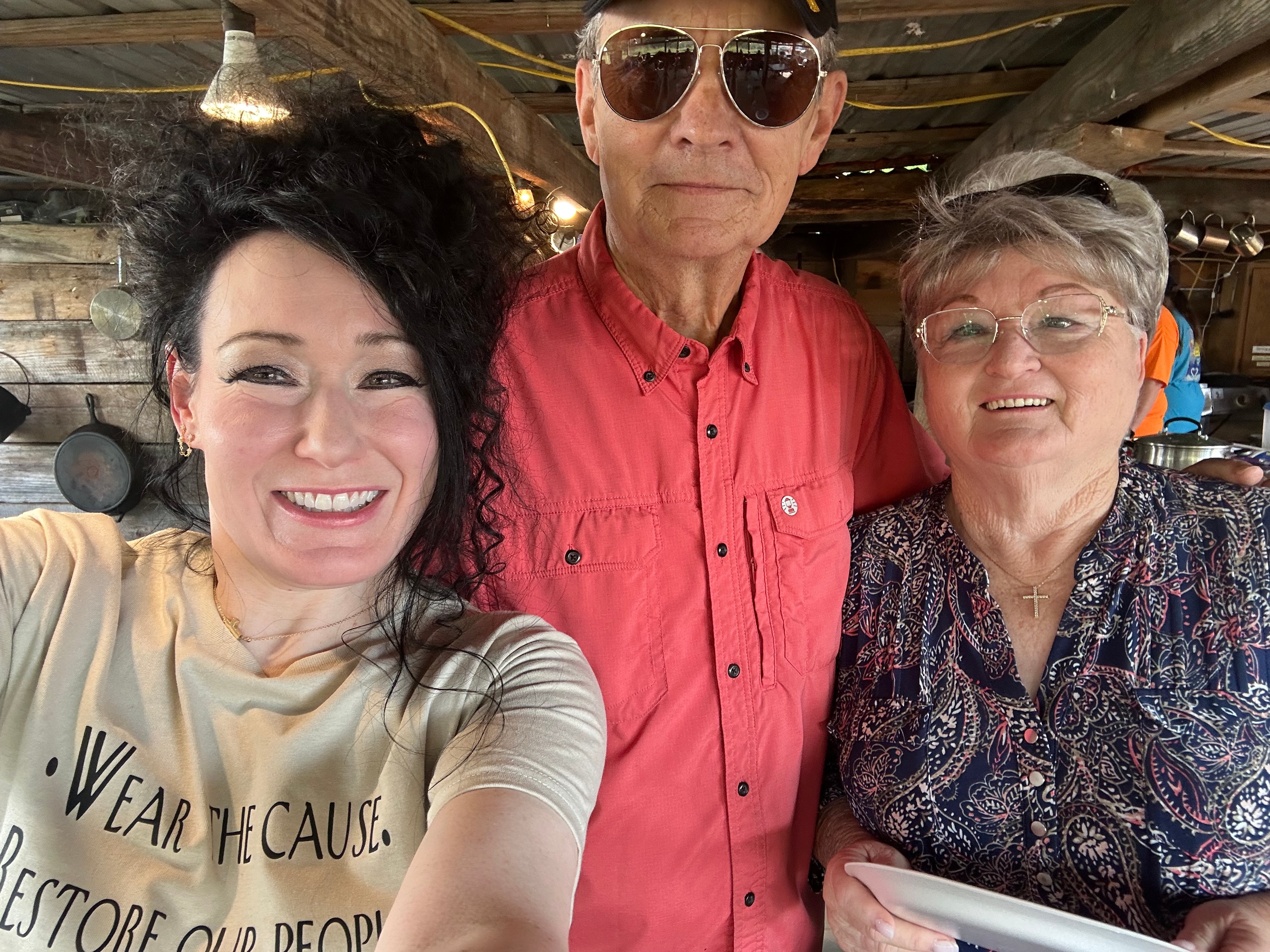 Three tribal members smiling at Green Tree Ceremony July 11, 2026