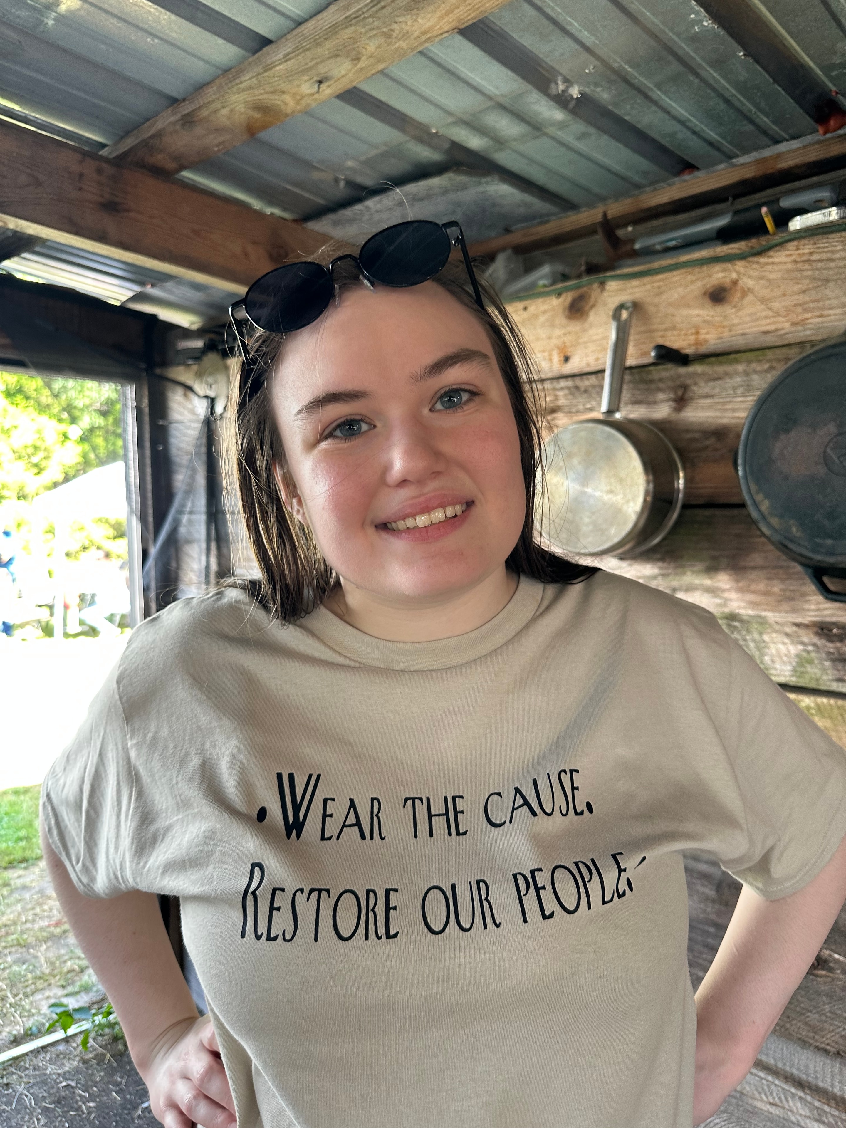 Tribal member wearing Wear the Cause Restore Our People shirt at Green Tree Ceremony July 11, 2026