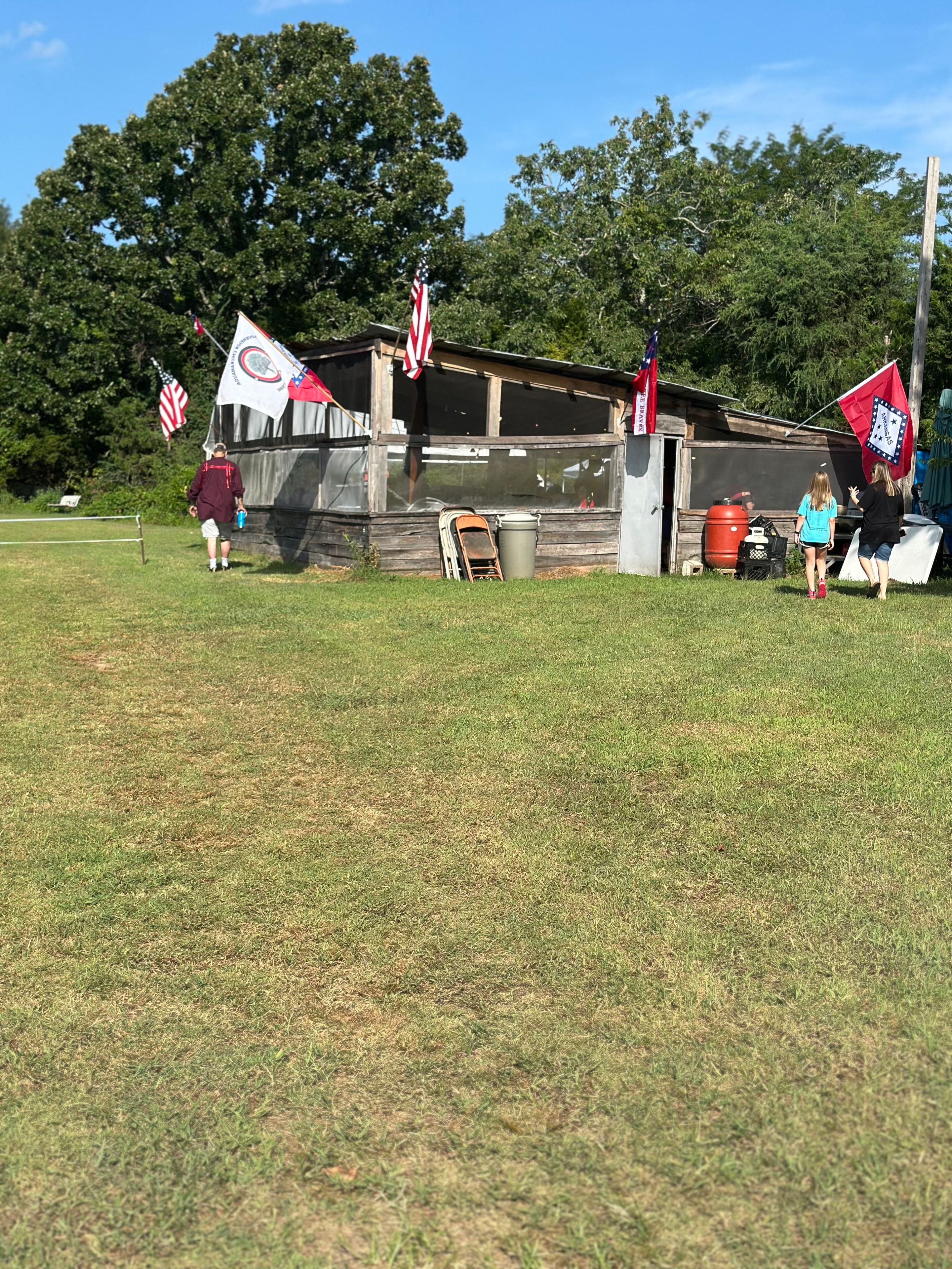 Ceremonial grounds with tribal and American flags flying at Green Tree Ceremony July 11, 2026