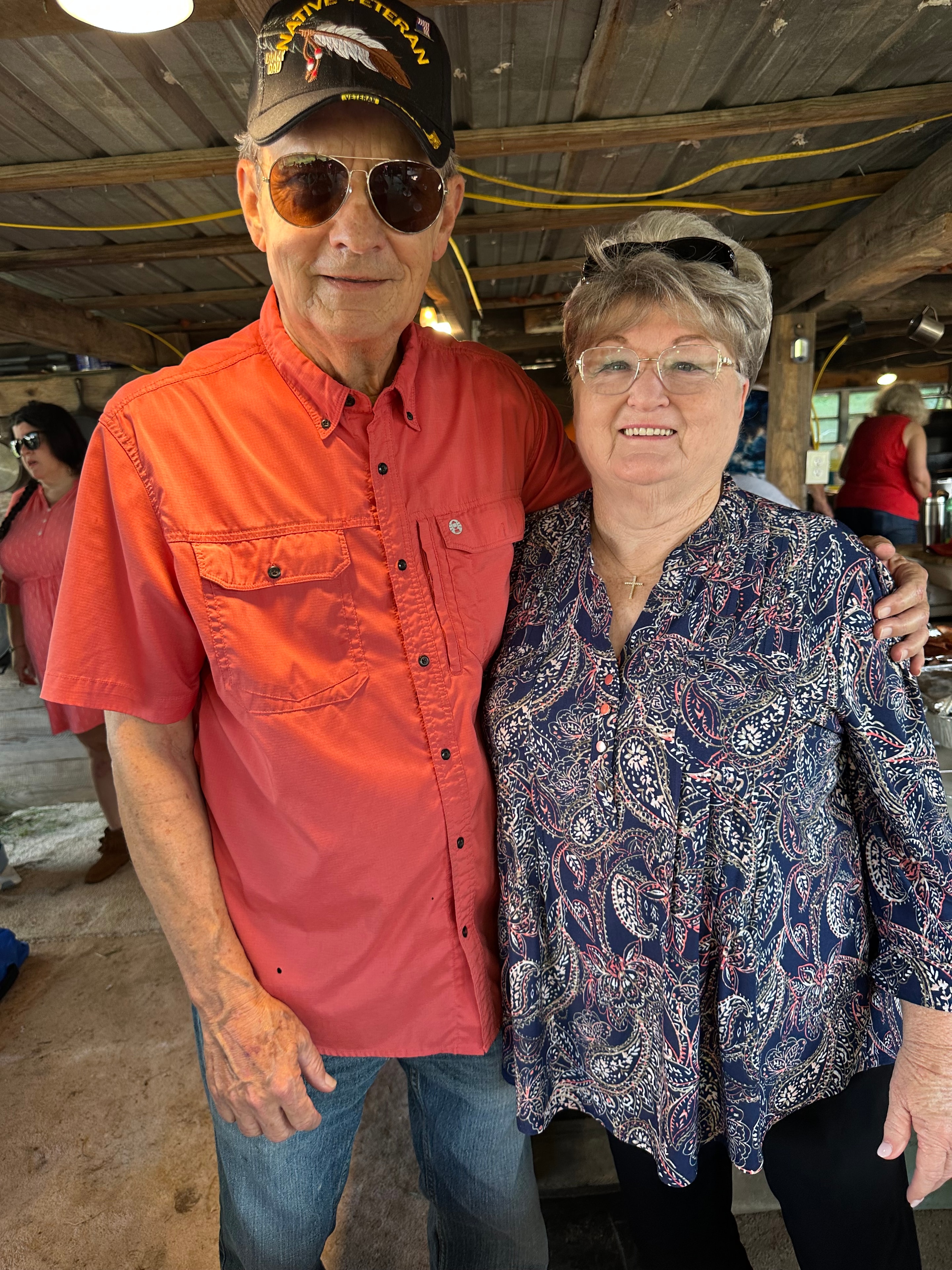 Two tribal members smiling together inside the cook house at Green Tree Ceremony July 11, 2026
