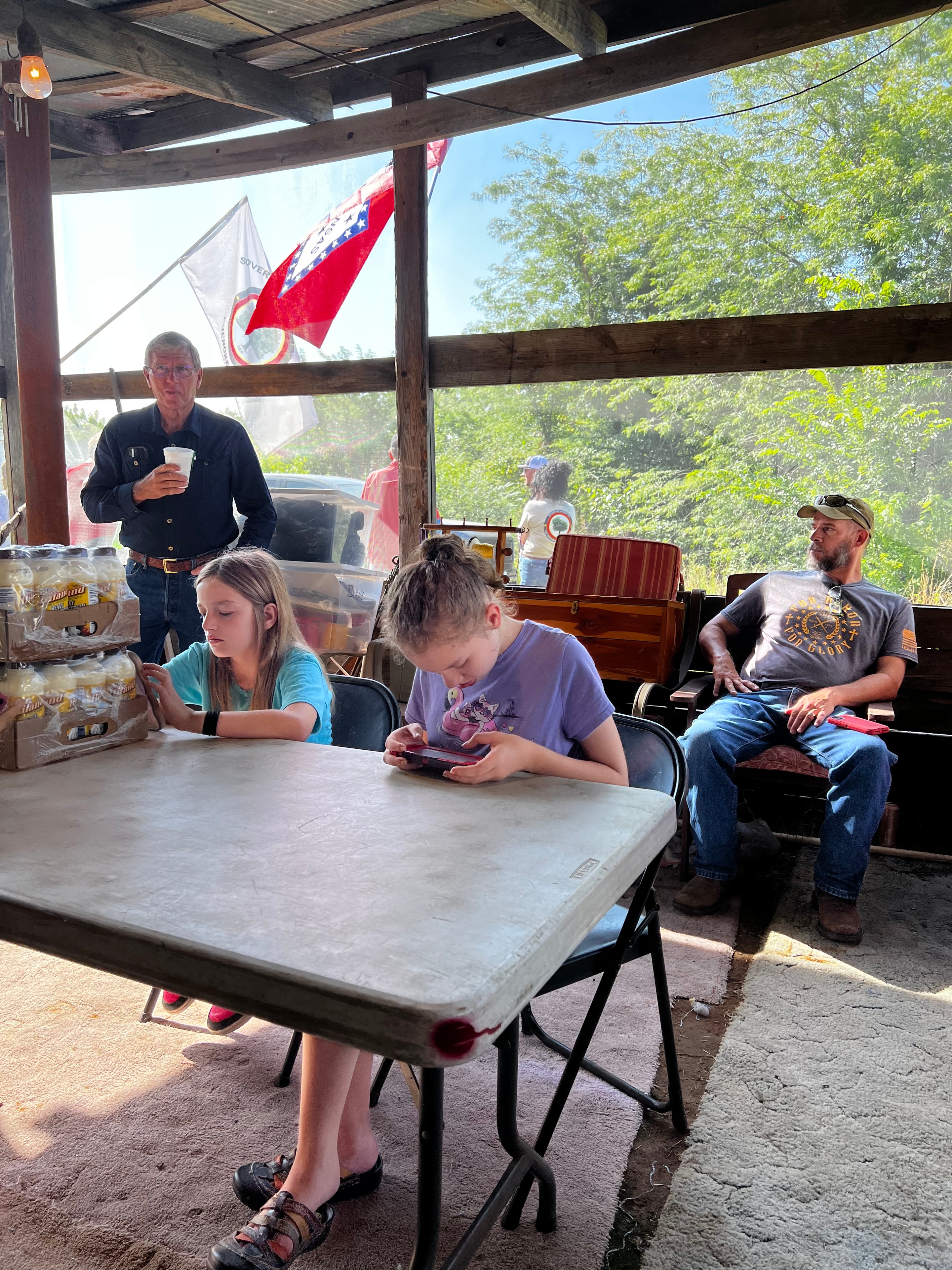 Tribal members and children seated inside the pavilion at Green Tree Ceremony July 11, 2026