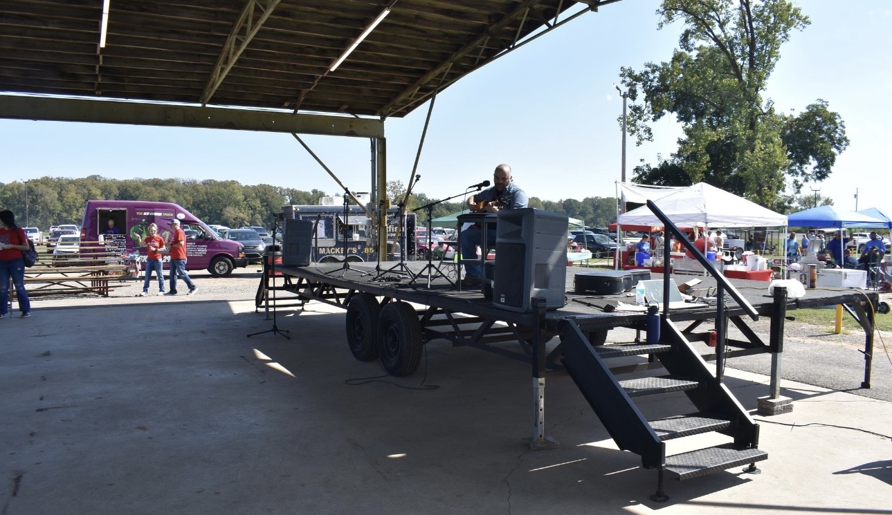 Ice Cream Truck and community members walking vendor row at Cherokee Chickamauga event