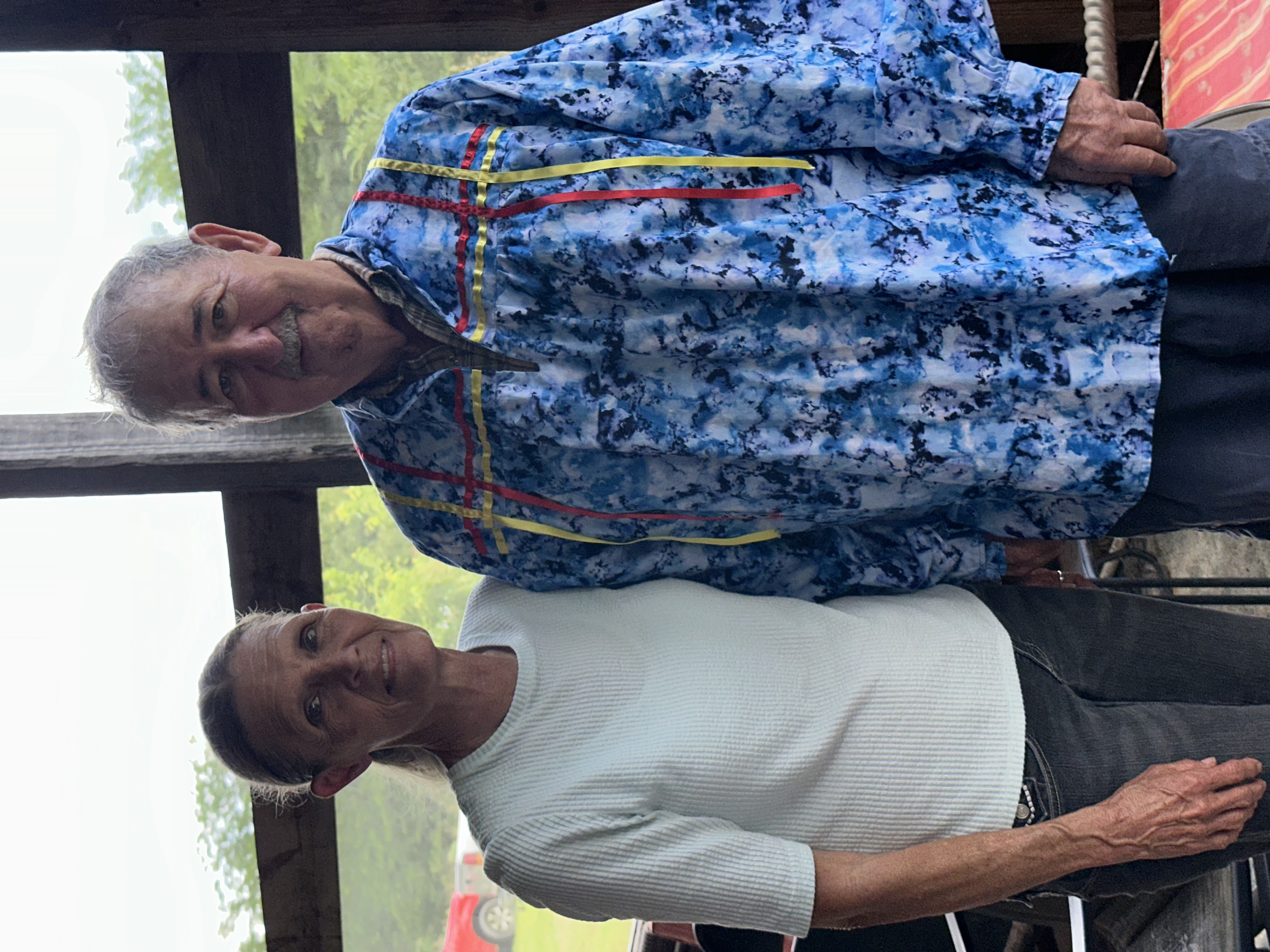 Two tribal members smiling together at Green Corn Ceremony 2026