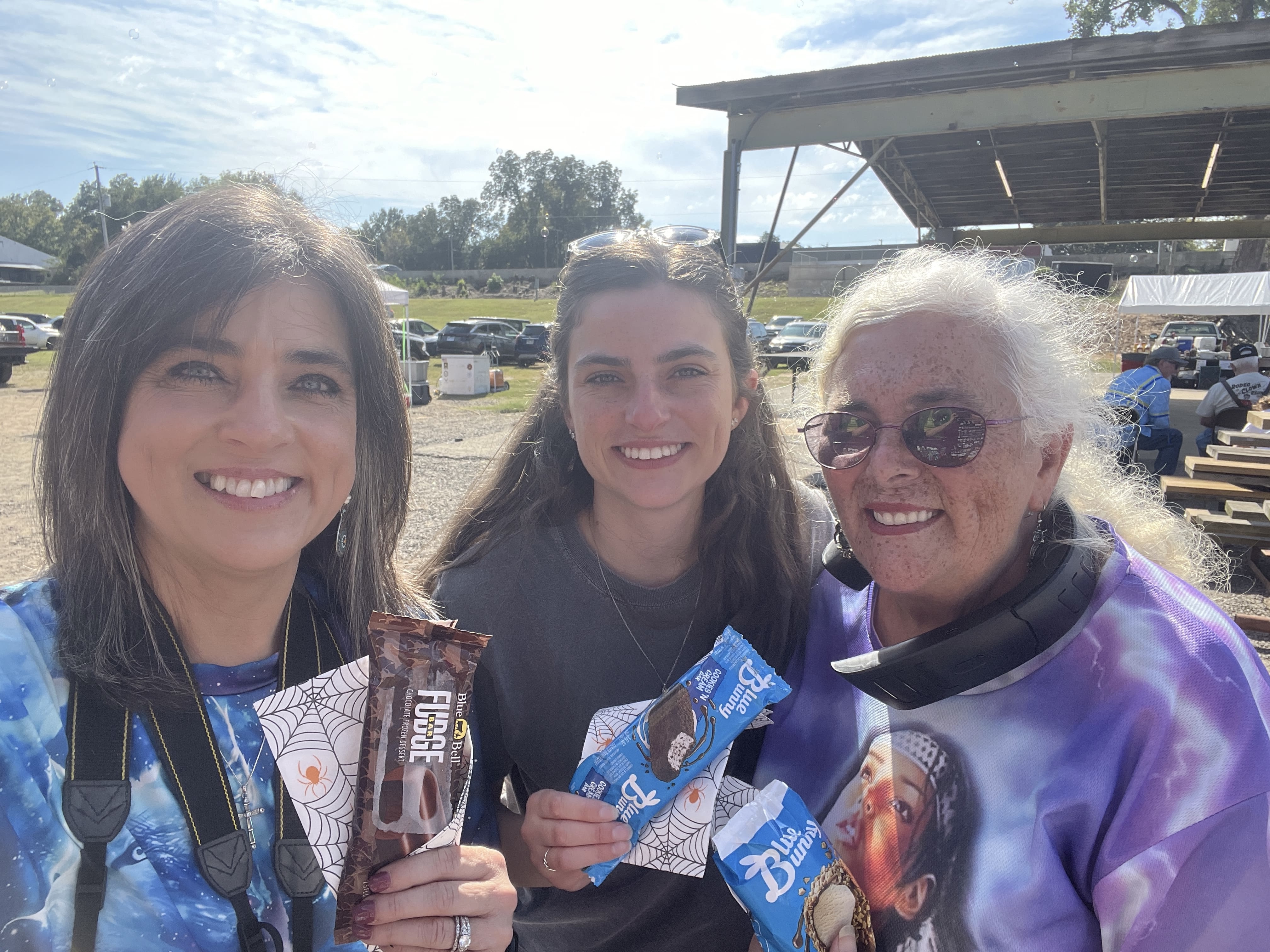 Three community members holding Blue Bunny and Blue Bell ice cream at October Festival 2025